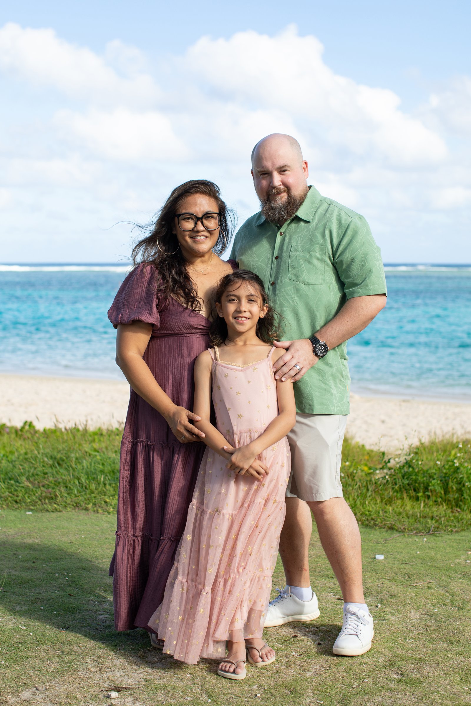 Nate, Andrea and Ella Aguirre standing on the beach in Guam.
